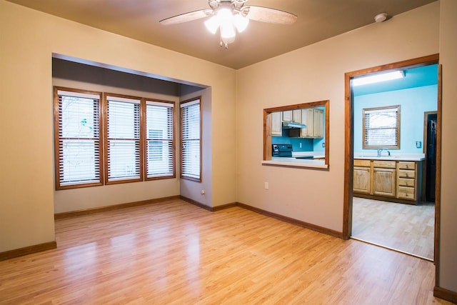 spare room featuring ceiling fan and light hardwood / wood-style floors