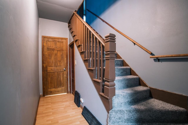 staircase featuring wood-type flooring