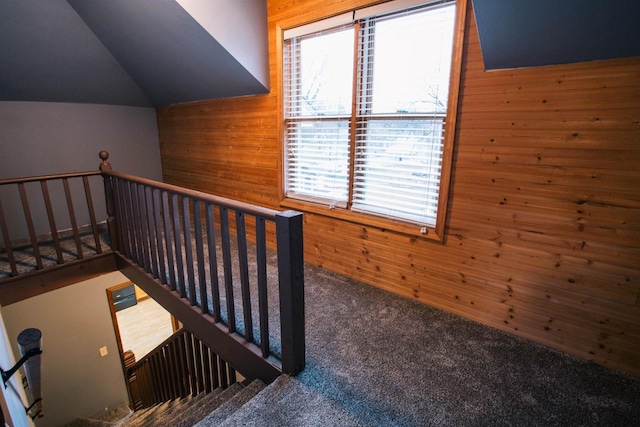 interior space featuring carpet flooring and wooden walls