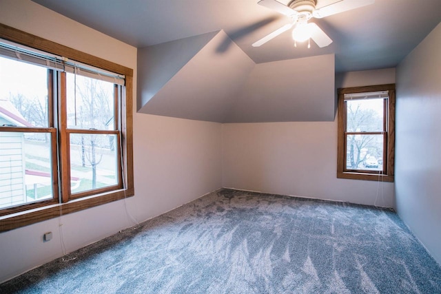 additional living space with carpet flooring, ceiling fan, and lofted ceiling