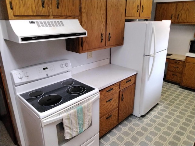 kitchen featuring range hood and white electric stove