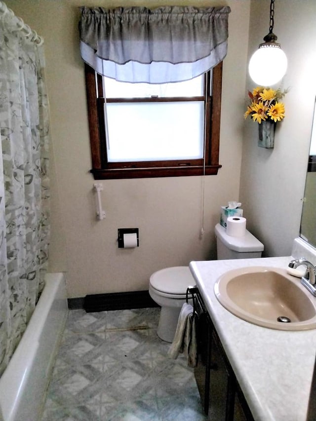 full bathroom featuring vanity, shower / bath combination with curtain, and toilet