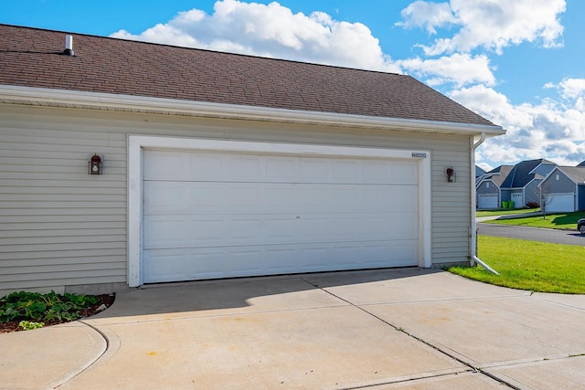 garage featuring a lawn