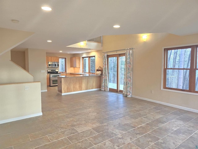 kitchen featuring kitchen peninsula and appliances with stainless steel finishes