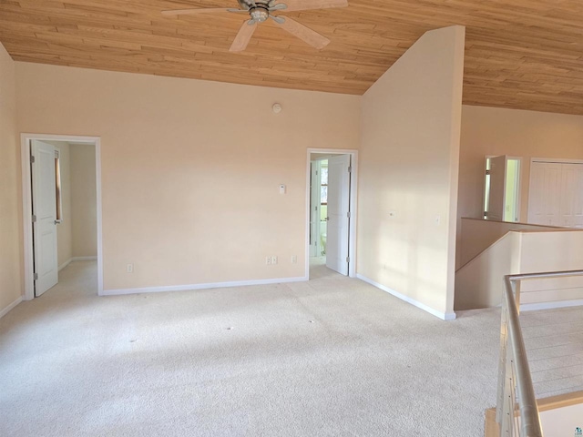 carpeted spare room with vaulted ceiling, ceiling fan, and wood ceiling