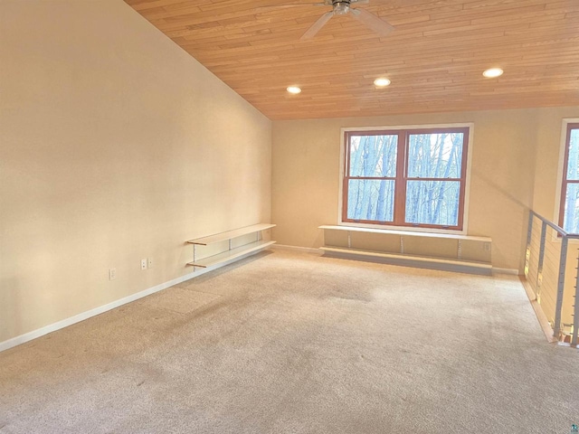 carpeted spare room featuring ceiling fan, wood ceiling, and lofted ceiling