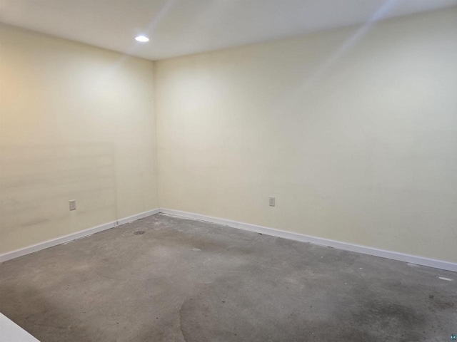 unfurnished room with concrete floors