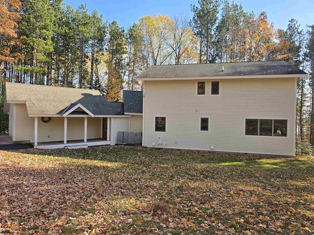 back of house with a lawn