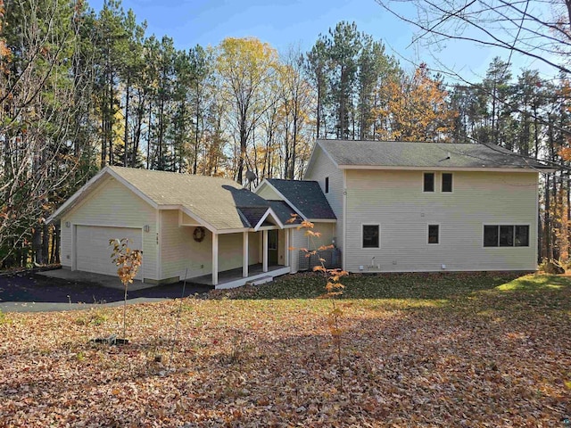 view of property with a garage and a front lawn