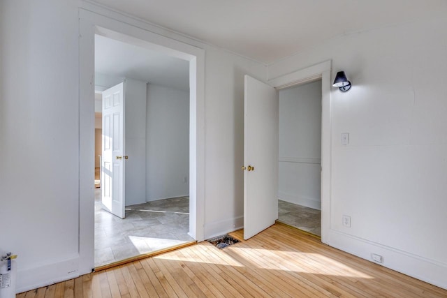 unfurnished bedroom featuring light wood-type flooring and a closet