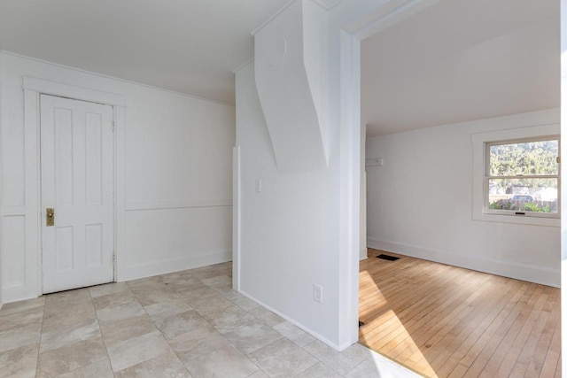 additional living space featuring light hardwood / wood-style floors