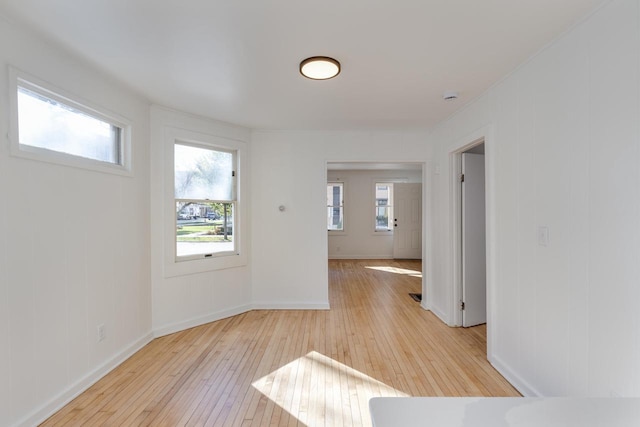 spare room with a wealth of natural light and light wood-type flooring