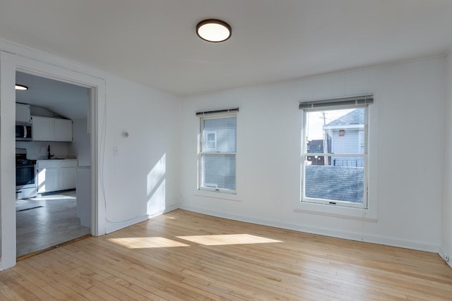 empty room with light wood-type flooring and sink