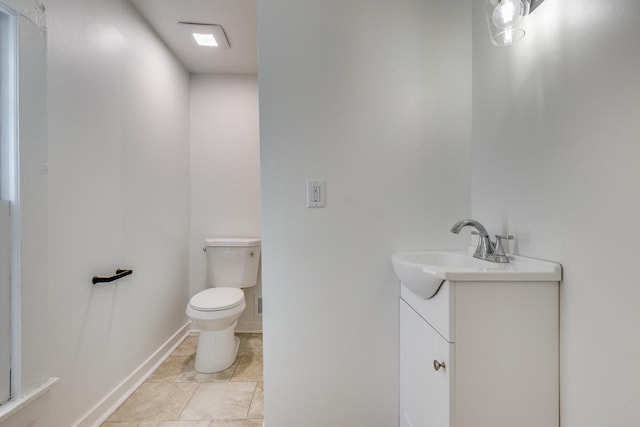 bathroom featuring tile patterned flooring, vanity, and toilet