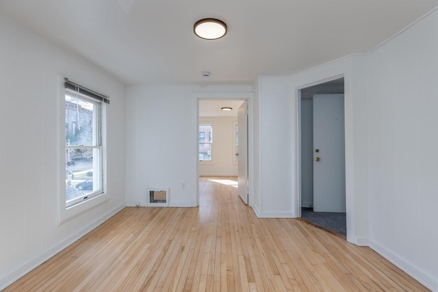 spare room with a healthy amount of sunlight and light hardwood / wood-style floors