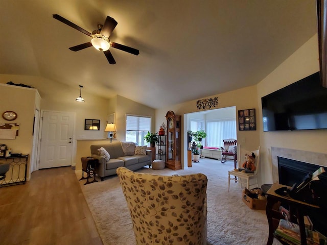 living room featuring ceiling fan and vaulted ceiling