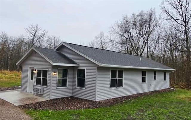 view of side of home featuring a patio area and a yard