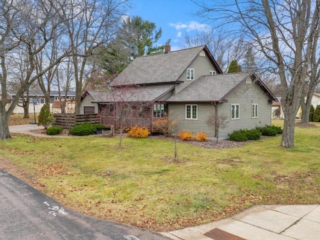 view of property exterior with a lawn and a deck