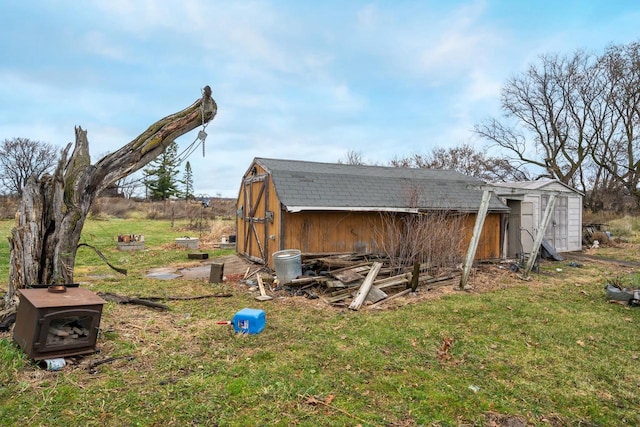 view of home's exterior featuring a yard and a storage unit