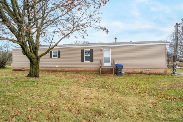 rear view of house with a lawn