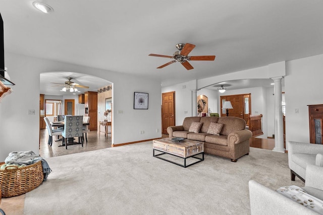 4207 Lost Dauphin Rd, De Pere, WI 54115 - living area with a ceiling fan, arched walkways, ornate columns, and light colored carpet