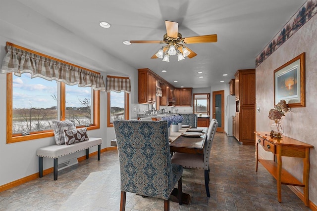 4207 Lost Dauphin Rd, De Pere, WI 54115 - dining space featuring stone finish flooring, a ceiling fan, and recessed lighting