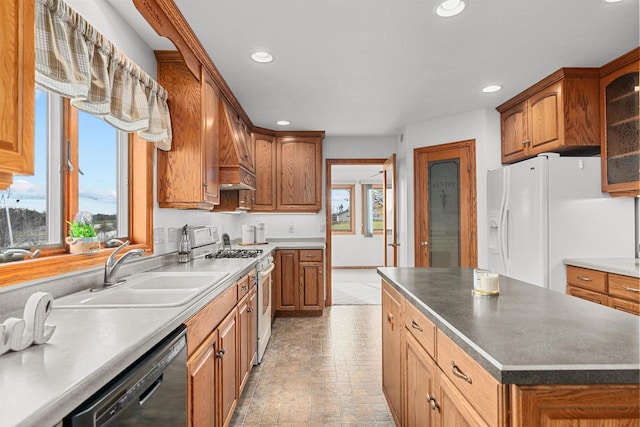 4207 Lost Dauphin Rd, De Pere, WI 54115 - kitchen featuring white appliances, recessed lighting, glass insert cabinets, brown cabinets, and a kitchen island