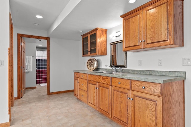 4207 Lost Dauphin Rd, De Pere, WI 54115 - kitchen with brown cabinets, glass insert cabinets, recessed lighting, and light flooring