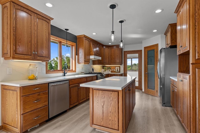 4207 Lost Dauphin Rd, De Pere, WI 54115 - kitchen featuring stainless steel appliances, light wood-type flooring, a kitchen island, brown cabinetry, and recessed lighting