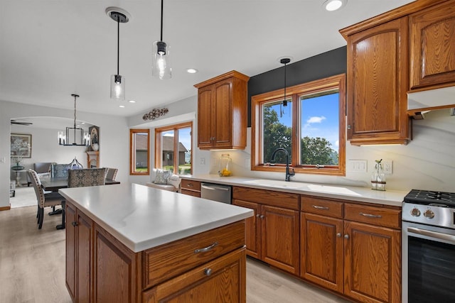 4207 Lost Dauphin Rd, De Pere, WI 54115 - kitchen featuring appliances with stainless steel finishes, light wood finished floors, brown cabinetry, light countertops, and recessed lighting