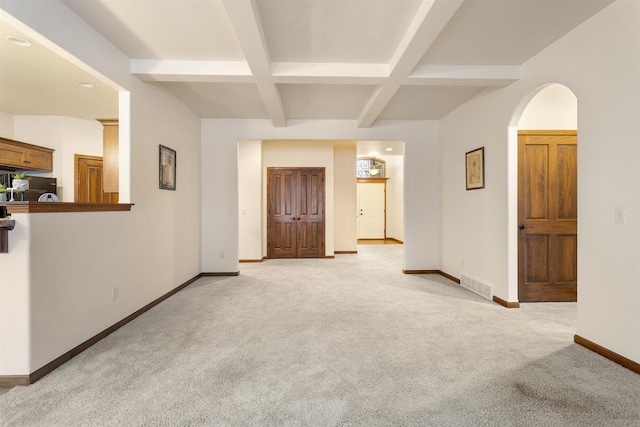 carpeted spare room with beamed ceiling and coffered ceiling