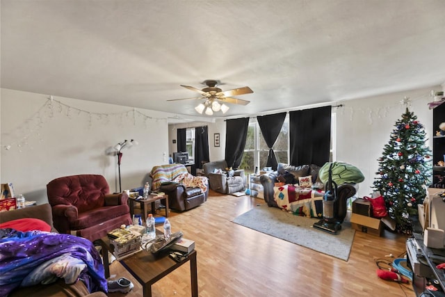 living room featuring ceiling fan and hardwood / wood-style floors