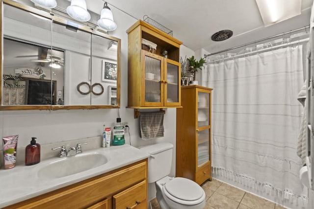 bathroom featuring vanity, tile patterned flooring, ceiling fan, a shower with shower curtain, and toilet