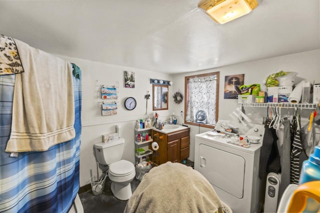 bathroom with washer / clothes dryer, vanity, and toilet