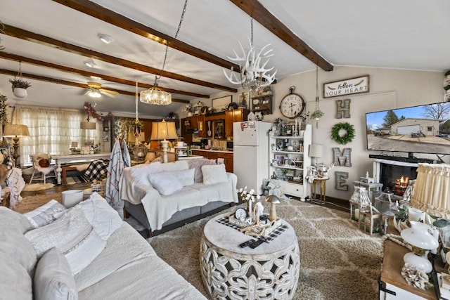 living room with vaulted ceiling with beams and ceiling fan with notable chandelier