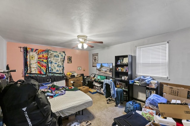 carpeted office featuring a textured ceiling and ceiling fan