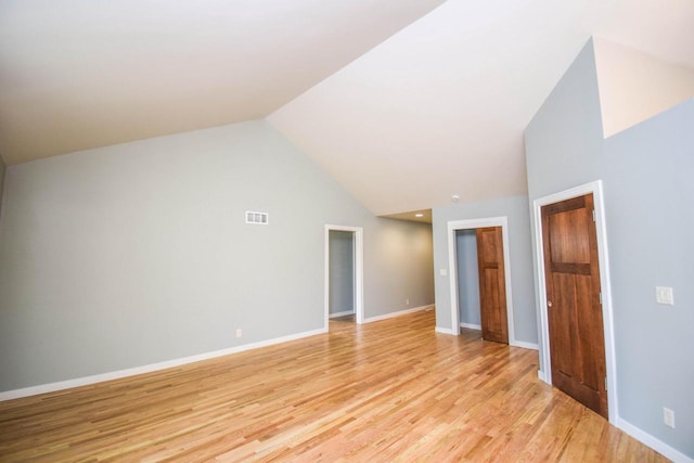 interior space featuring lofted ceiling and light wood-type flooring