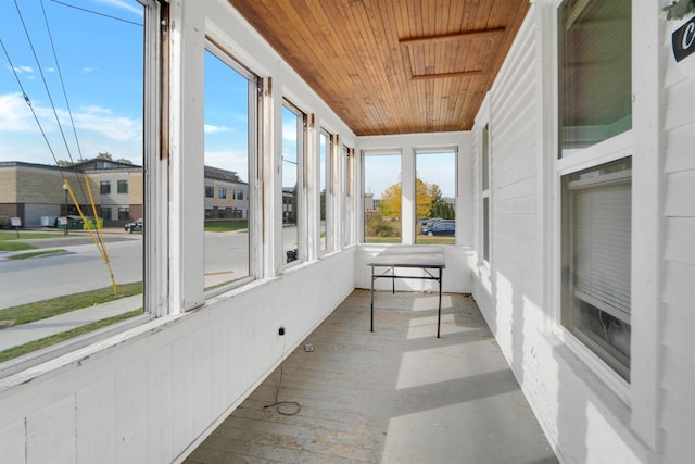 unfurnished sunroom featuring wood ceiling