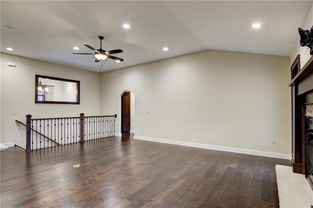 unfurnished living room featuring ceiling fan, lofted ceiling, and dark wood-type flooring