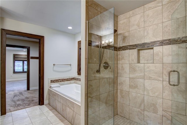 bathroom with tile patterned flooring and separate shower and tub