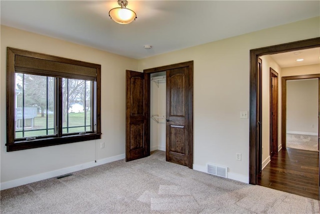 unfurnished bedroom with a closet and carpet