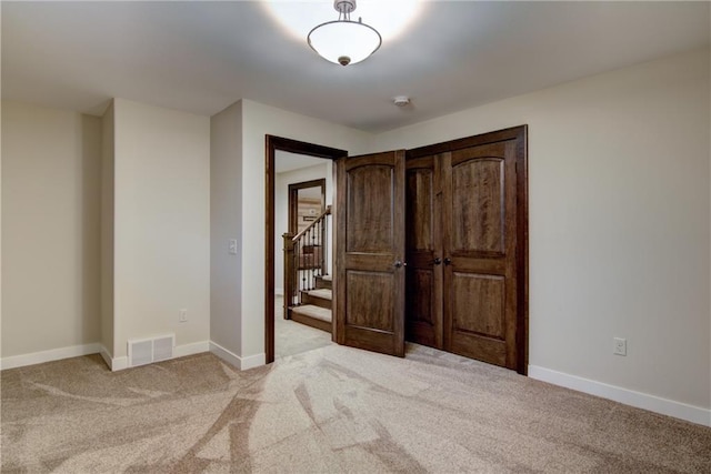 unfurnished bedroom with light carpet