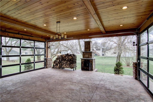 unfurnished sunroom with a healthy amount of sunlight, wooden ceiling, and beam ceiling