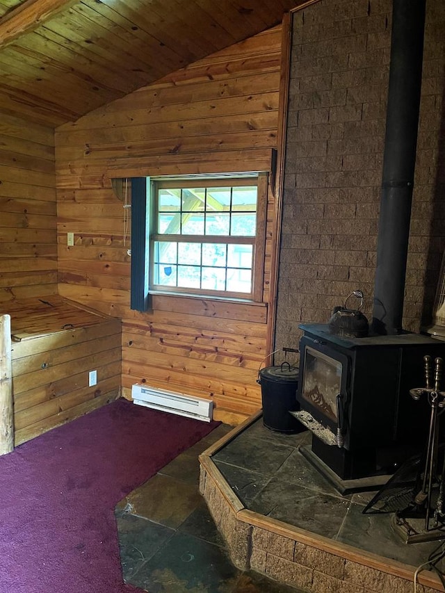 interior space featuring a wood stove, wood walls, wooden ceiling, and vaulted ceiling