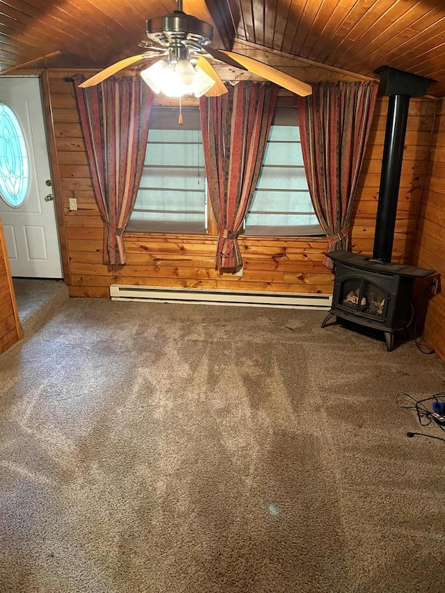 interior details with carpet, wood walls, wood ceiling, and a wood stove