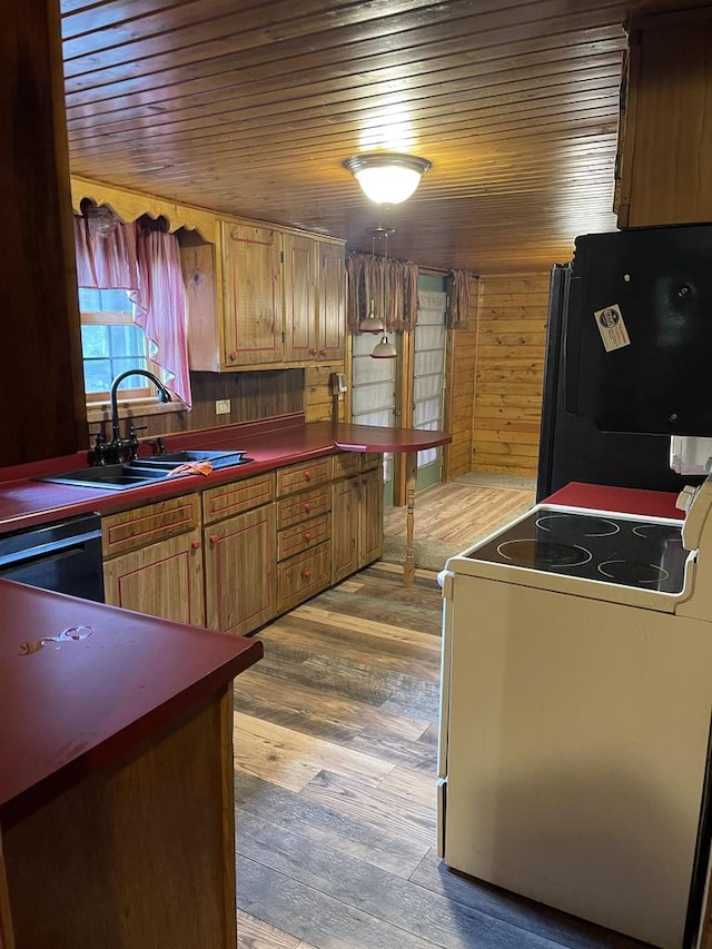 kitchen with wood walls, black appliances, sink, hardwood / wood-style flooring, and wood ceiling