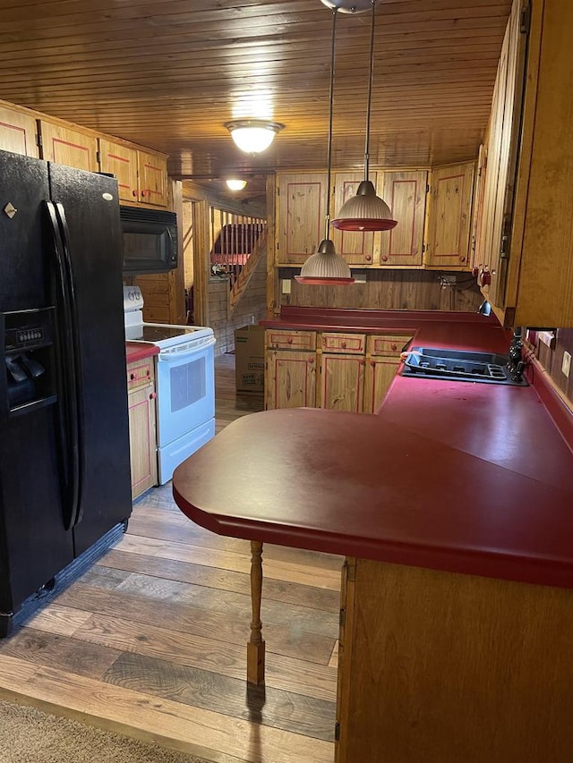 kitchen featuring hardwood / wood-style floors, decorative light fixtures, wood ceiling, and black appliances