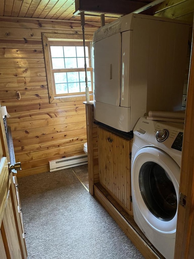 laundry area with a baseboard radiator, wooden ceiling, washer / clothes dryer, wood walls, and carpet