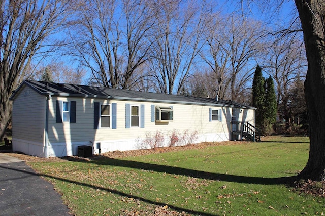 view of home's exterior featuring a yard and cooling unit