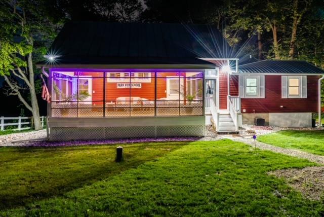 rear view of property with a lawn